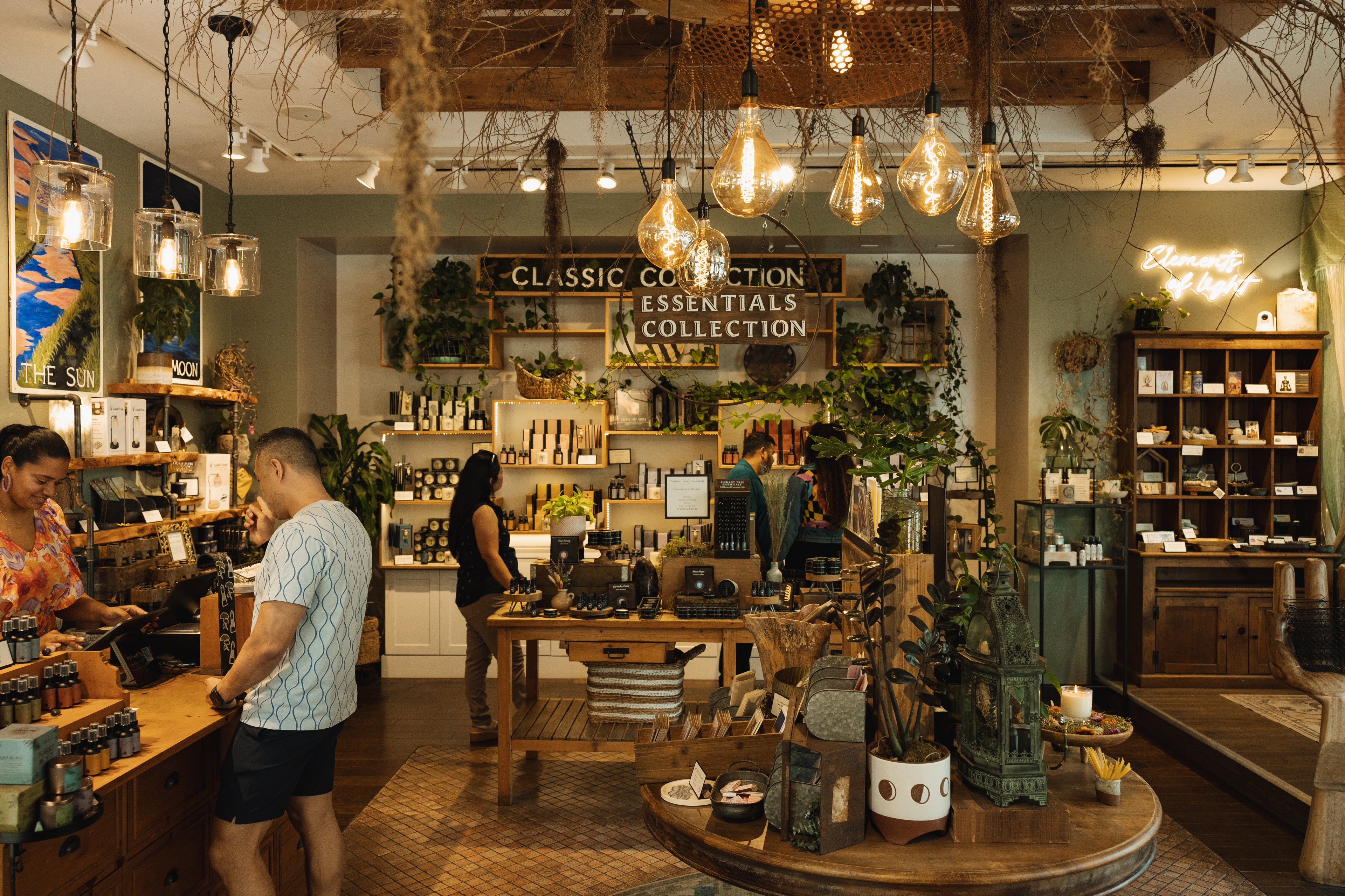 Interior of a store with wooden shelves, plants, and decorative items.