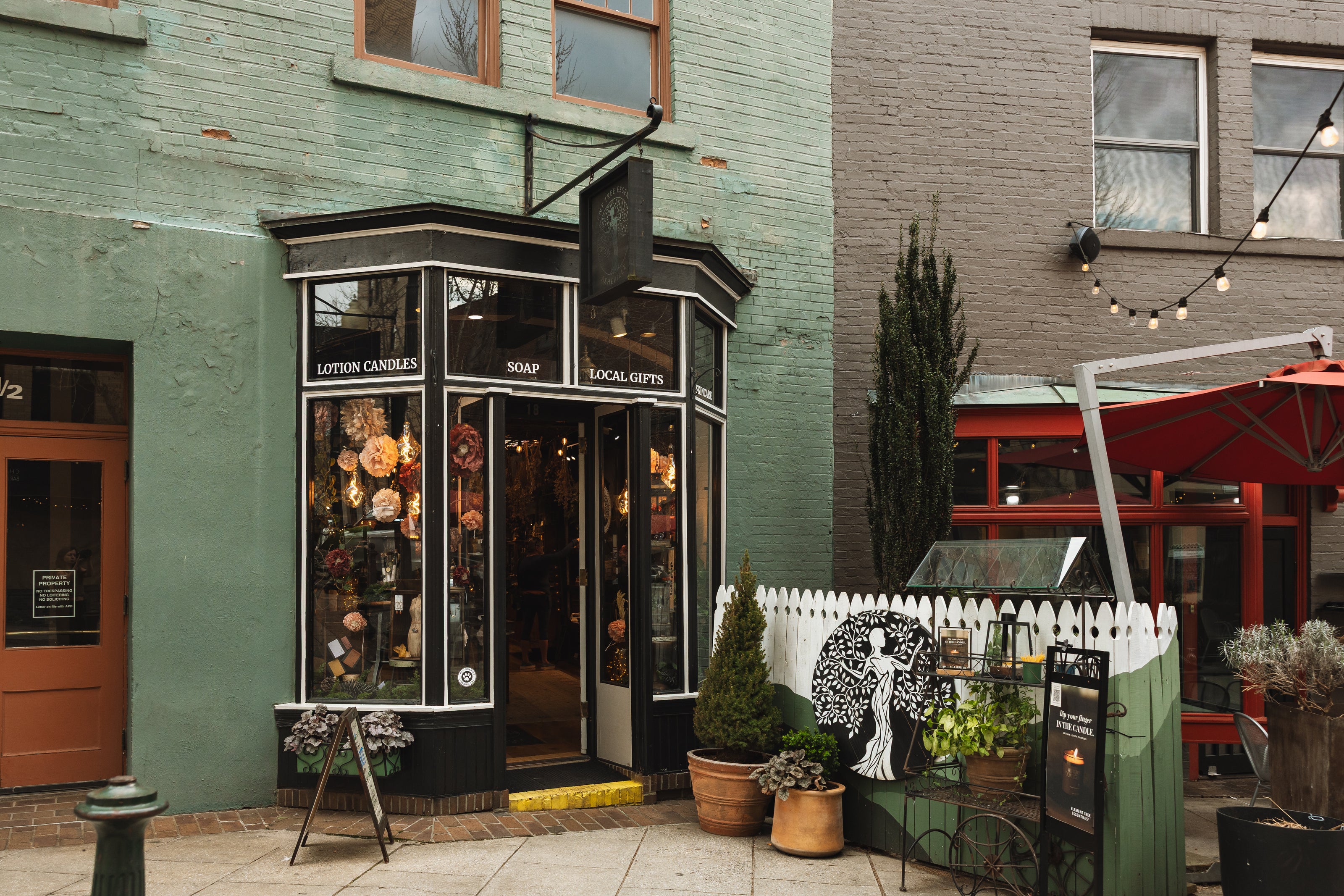 Small store front with outdoor seating area on a city street