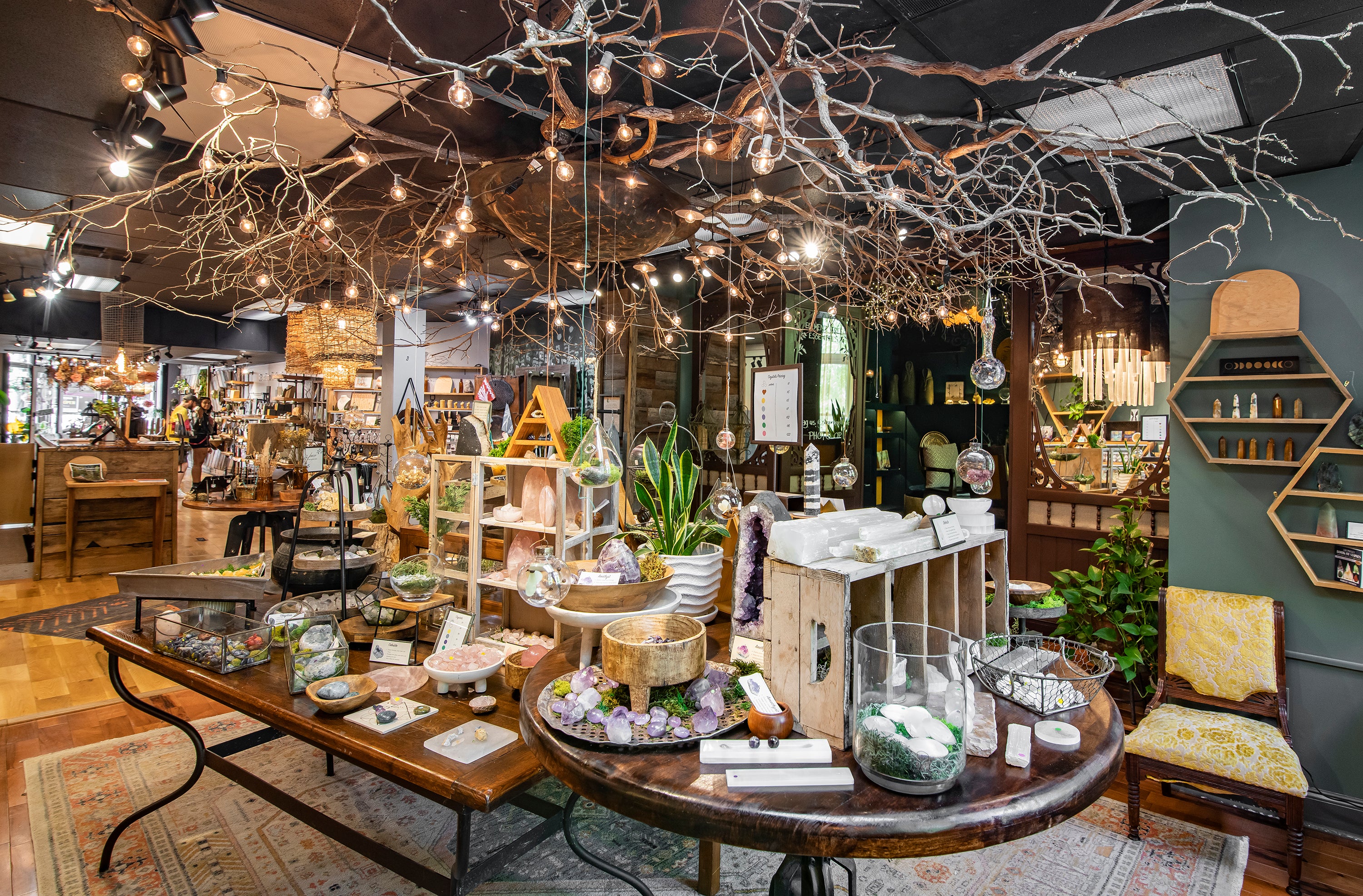 Decorative interior with tables, chairs, and decorative elements in a store setting.